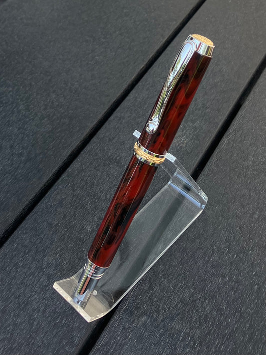 Mahogany Obsidian - Handcrafted Rollerball Pen.  This stunning pen is made with TruStone, a combination of real stone powder and acrylic resin, and features Rhodium with Gold accents for a luxurious look.