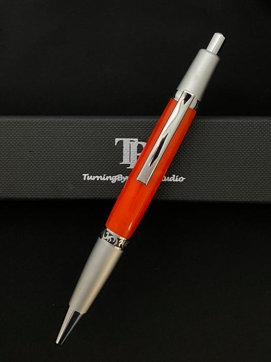 Click ballpoint pen, chrome with Bright Mango colored barrel