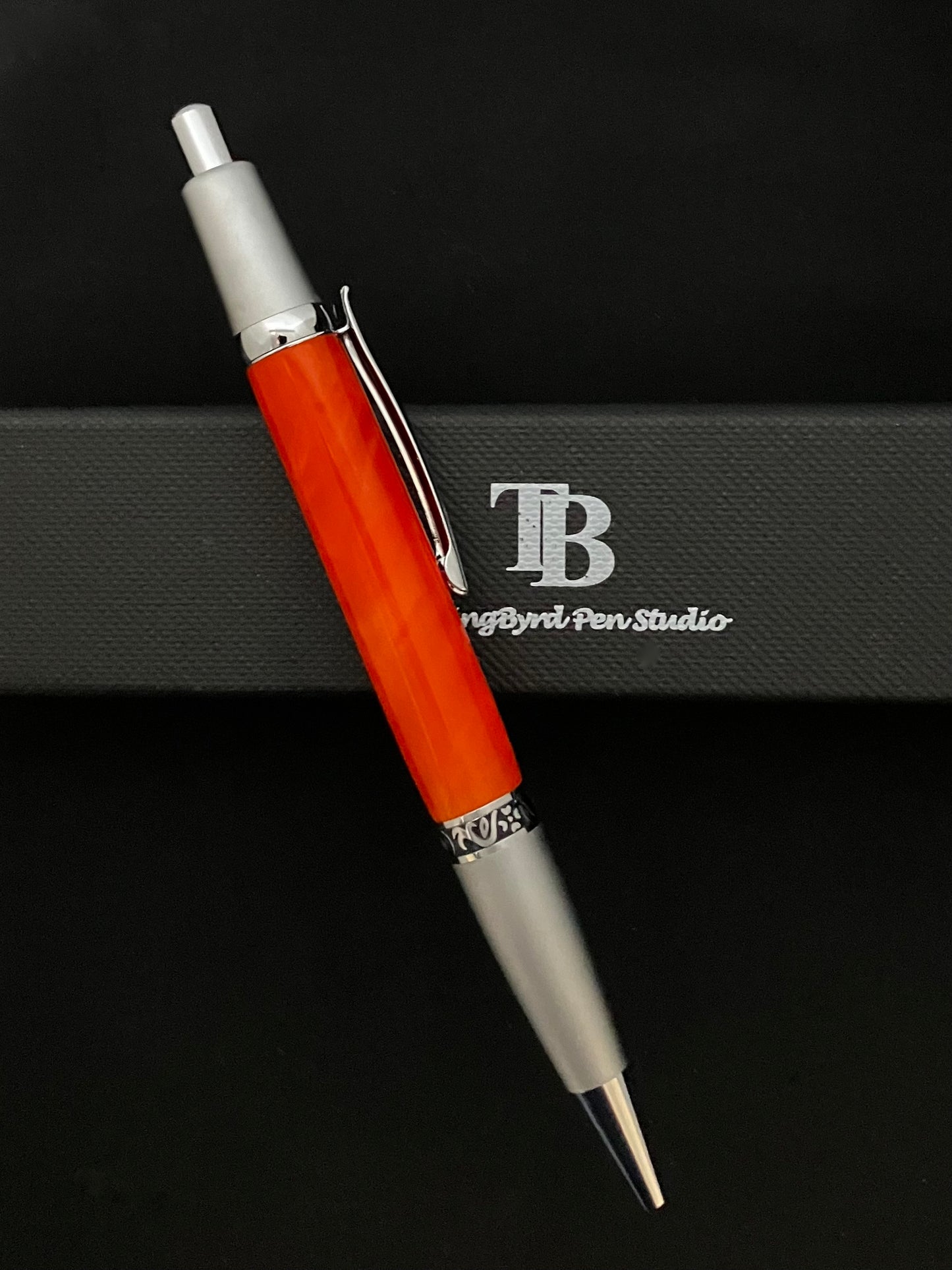 Click ballpoint pen, chrome with Bright Mango colored barrel
