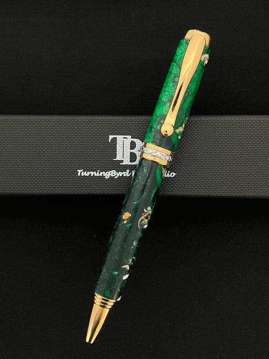Gold plated twist ballpoint pen with sparkling green resins with bits of sea shells included!