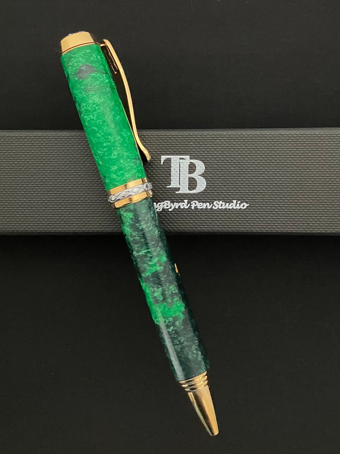 Gold plated twist ballpoint pen with sparkling green resins with bits of sea shells included!