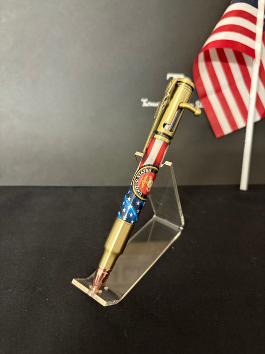 USMC Bolt Action Ballpoint pen with USMC insignia andd American flag design on a black background