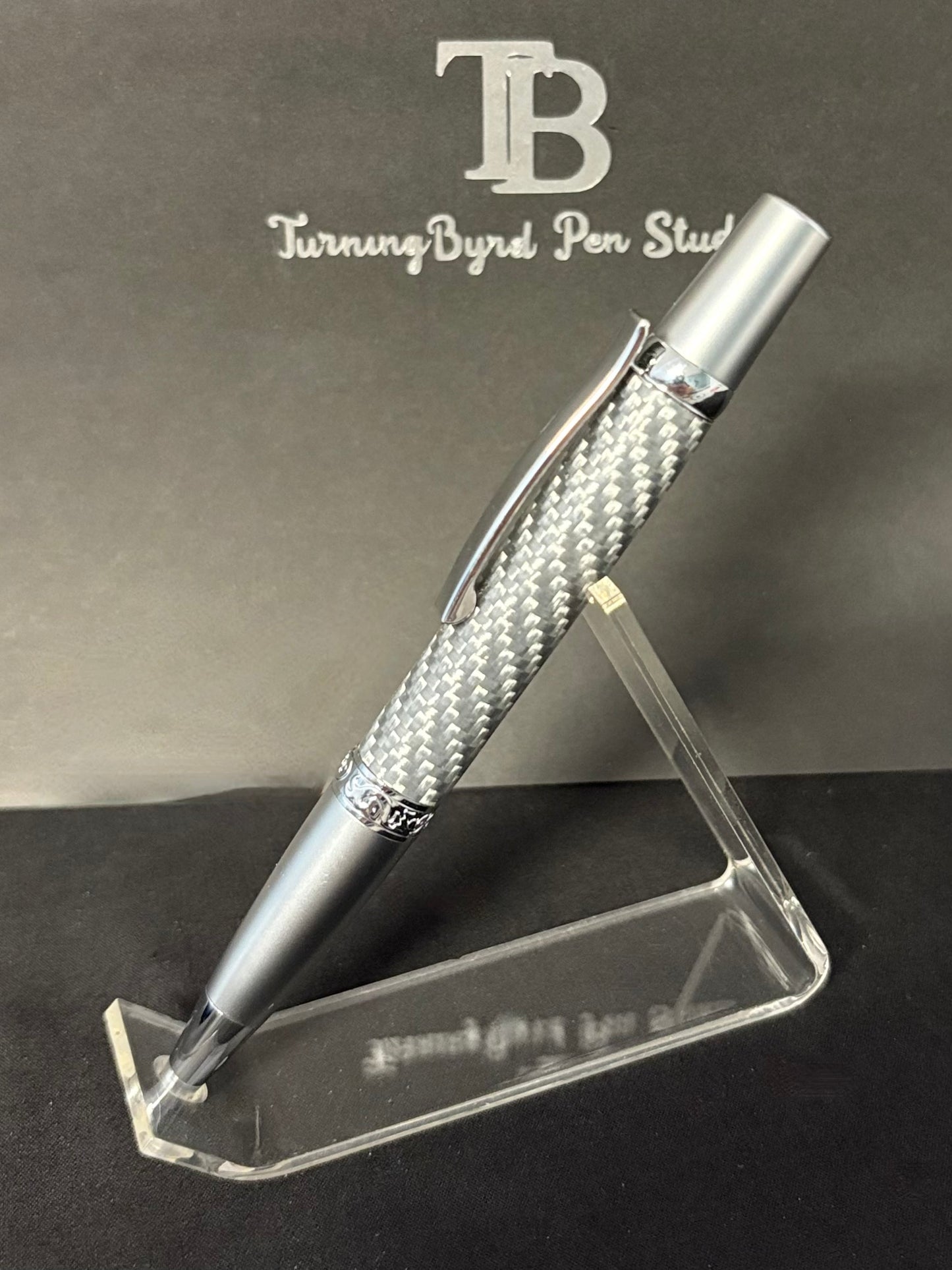 Silver carbon fiber pen with  'Turning Byrd Pen Studio' branding.