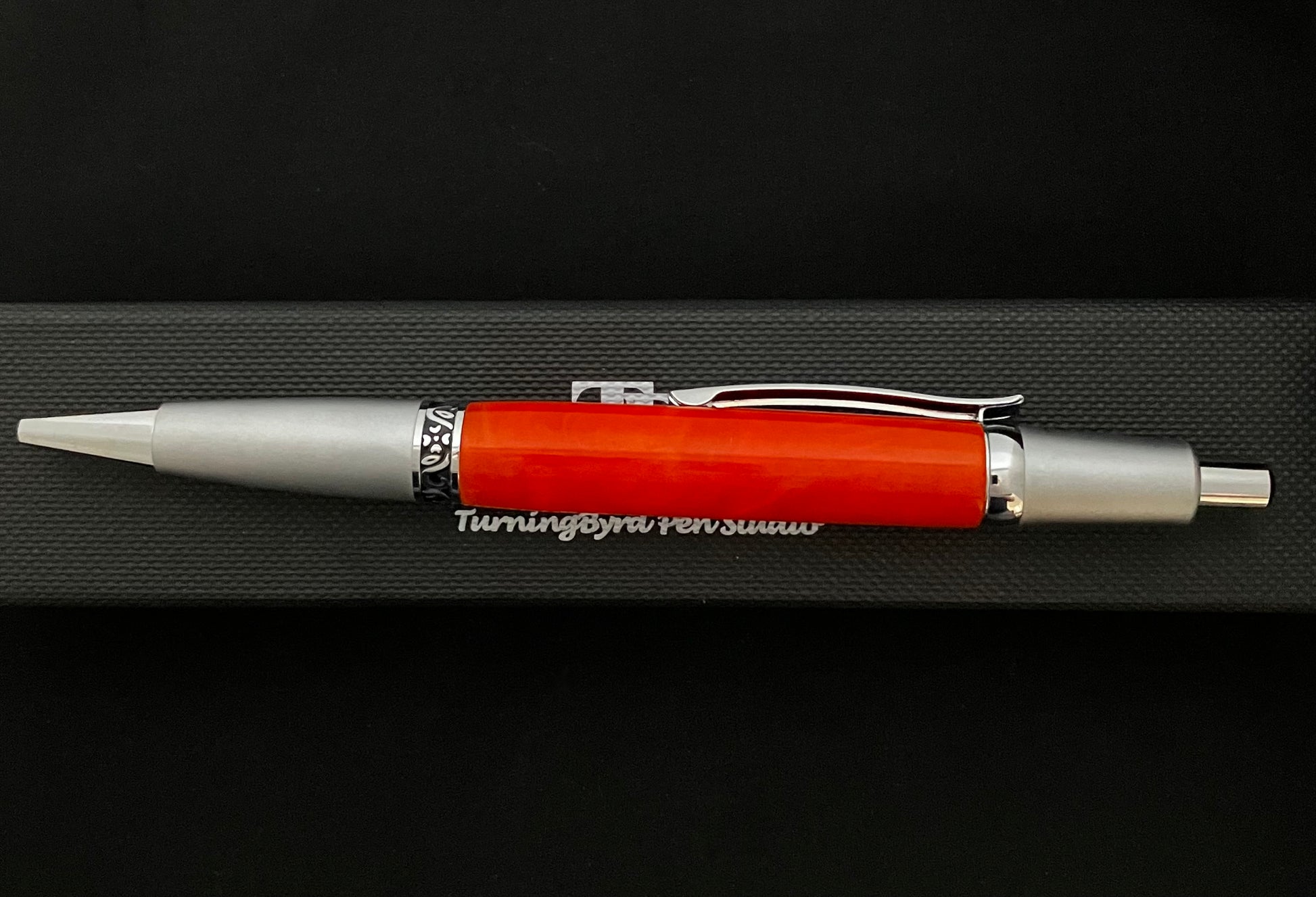 Click ballpoint pen, chrome with Bright Mango colored barrel